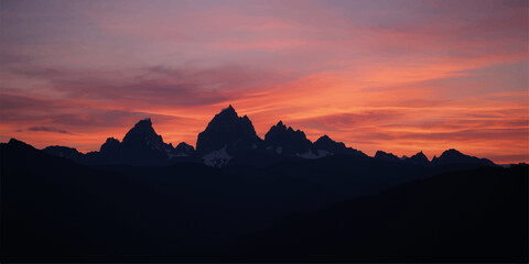 Golden sunrise and a vibrant orange sunset over the serene mountain landscape