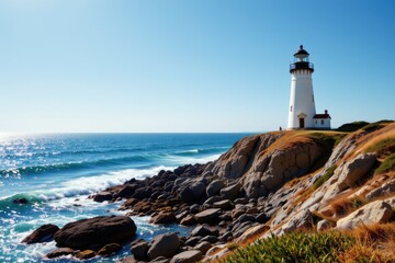 Scenic Lighthouse on Rocky Coastline with Calm Ocean Waves Under Clear Blue Sky