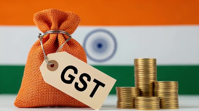 Orange Bag With GST Tag and Gold Coins Stacked in Front of Indian Flag