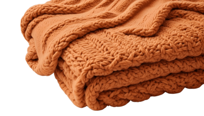 A richly textured, chunky knit terracotta-colored throw blanket is artfully draped against a transparent background, showcasing its intricate cable knit design and soft, inviting texture