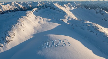 Aerial View of Snowy Mountain Range with "2026" Inscribed in Snow