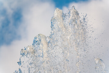 Splashes and jets of water against light background.