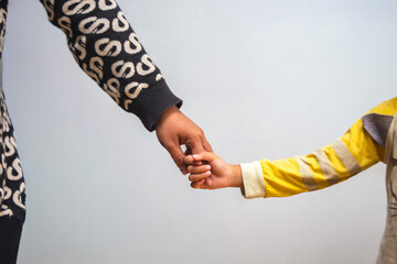 Mother and daughter holding hands