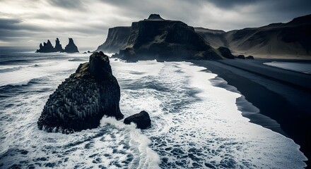 Dramatic black sand beach with basalt stacks and cliffs in vik, iceland