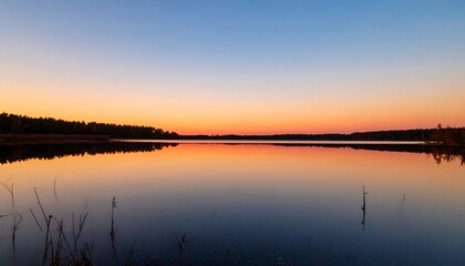 Naklejka premium Sunset Over a Calm Lake.