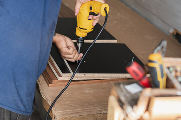 DIY furniture construction with electric drill and particle board