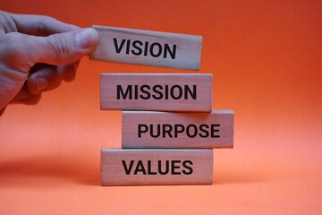 wooden blocks labeled with inspirational terms such as vision, mission, purpose, and values, symbolizing strategic business and personal development concepts