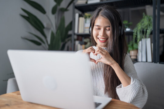 Beautiful asian young woman video call on laptop online communication Remote dating at a distance online dating.