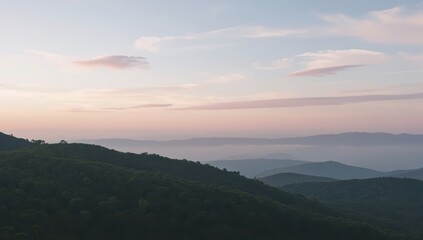 A serene vista of layered mountain ranges at dawn, bathed in soft, pastel hues and atmospheric mist.
