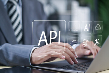 API, Application Programming Interface, information technology, modern technology and networking. Person using laptop with software development tool, cloud computing, global network, and security.