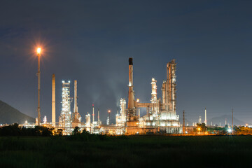 Fototapeta premium Petrochemical plant in thailand at night. Industrial architecture with gas flare or flare stack in operation. Large scale business investment site for processing and production of fuel and power.