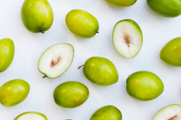 Green jujube fruits on white background.