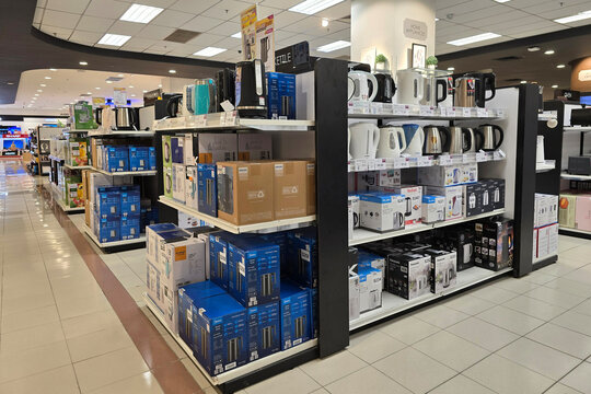 Penang, Malaysia &ndash; Aug 23, 2025: Assorted electric kettles from brands like Philips, Tefal, Panasonic, Elba, and Midea displayed neatly on retail shelves in the kitchen appliances section.