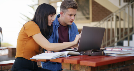 Laptop, textbook and people at university with studying for test, assignment or exam together. Computer, education and students talking for assessment with research for learning at college campus.