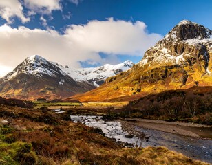 Scenic valley with snow-capped mountains and a flowing river under a vibrant sky.