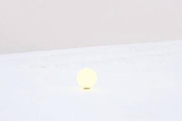 Glowing orb rests on snowy, flat expanse