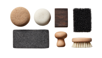Assorted cleaning brushes and pads in a flat lay.  Various shapes and colors, including light brown, dark brown, dark gray, and off-white