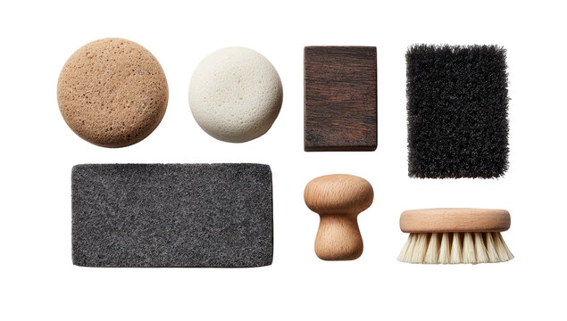 Assorted cleaning brushes and pads in a flat lay.  Various shapes and colors, including light brown, dark brown, dark gray, and off-white