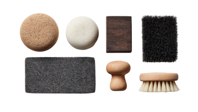 Assorted cleaning brushes and pads in a flat lay.  Various shapes and colors, including light brown, dark brown, dark gray, and off-white