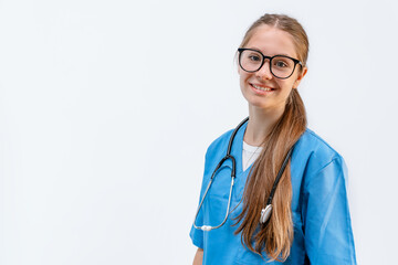 Portrait of a young Caucasian female doctor in a blue uniform on an isolated background. intern or...