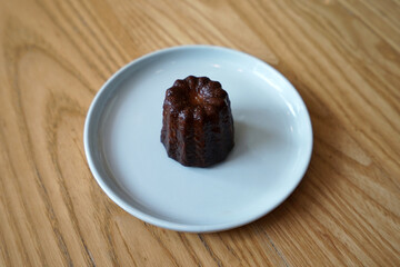 The Canelé (Canele) de Bordeaux, French bakery pastry confection- rich custardy interior enclosed by a thin caramelized shell