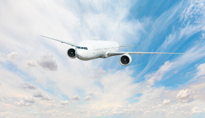 White passenger airplane flying in the sky amazing clouds in the background - Travel by air transport