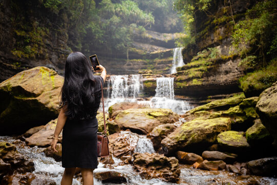 Girl in front of waterfall