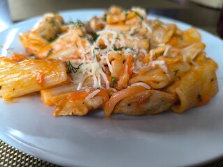 Delicious spaghetti carbonara with bacon and creamy sauce on white plate