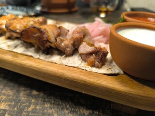 delicious tender chicken shashlik lies on a cutting board on pita bread
