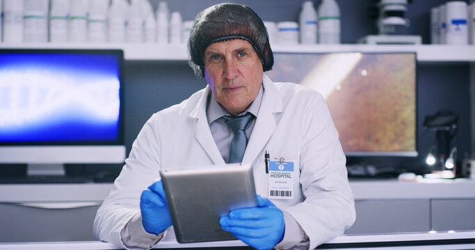 Man, science and portrait with tablet in lab for medical research, microbiology study and hairnet for hygiene. Scientist, PPE for safety and mature doctor with digital results for health innovation