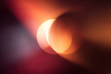 Abstract, vibrant, orange, and muted tones creating two overlapping circles, suggestive of a cosmic, glowing object