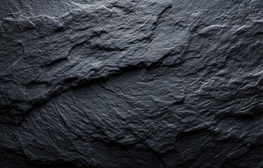 Dark gray stone surface with textured, uneven surface