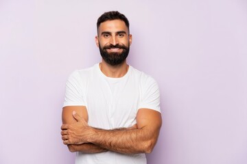 Stock photo of handsome bearded man smiling in white t shirt with arms crossed isolated