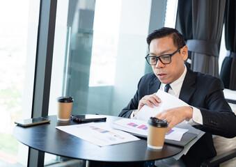 Asia businessman working with paper work at office	