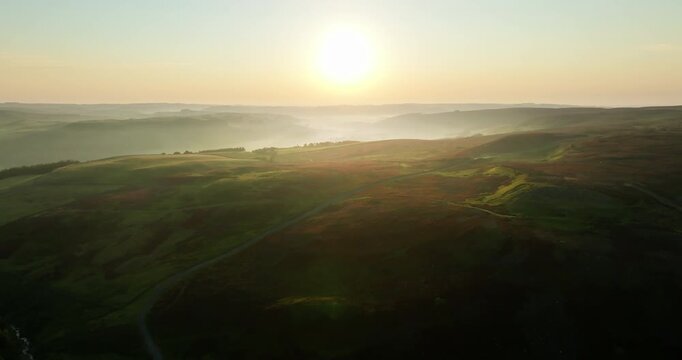 Flying above moorland at sunrise