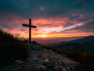Wooden Cross Silhouetted Against Colorful Mountain Sunset