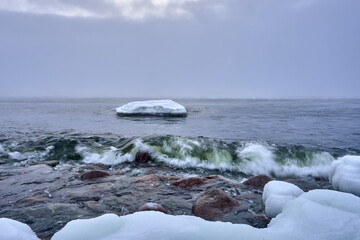 winter landscape with snow storm and sea