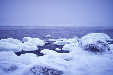 winter landscape with snow storm and sea