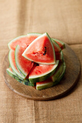 Slices of fresh watermelon on rustic wooden background.