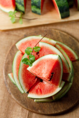 Slices of fresh watermelon on rustic wooden background.