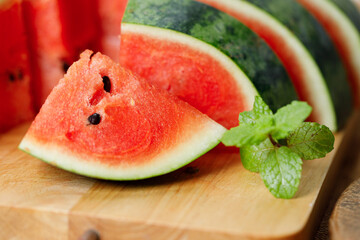 Slices of fresh watermelon on rustic wooden background.