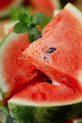 Slices of fresh watermelon on rustic wooden background.