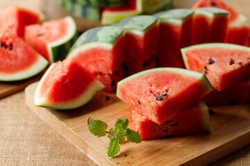 Slices of fresh watermelon on rustic wooden background.
