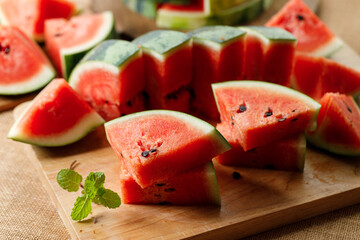Slices of fresh watermelon on rustic wooden background.