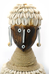 Balinese decorative wooden figurine with seashells on white background