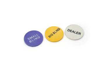 three colorful poker chips with inscriptions “Dealer,” “Small Blind,” and “Big Blind,” isolated on a clean white background