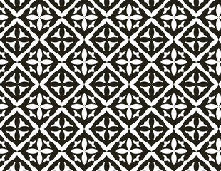 symmetrical, black and white geometric pattern with repeated quatrefoil and diamond shapes.