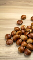 Fototapeta premium Chestnuts on a wood surface