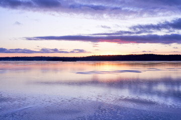 sunset on the icy lake in winter