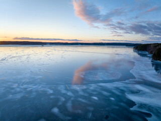sunset on the icy lake in winter